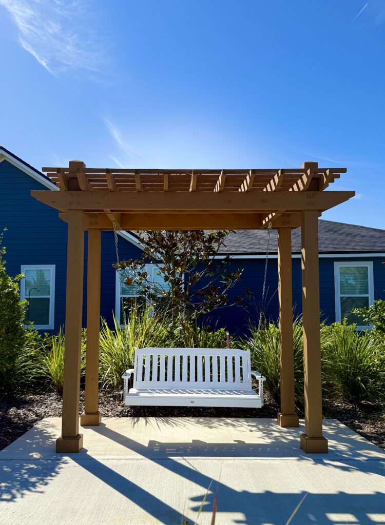 Pergola porch swing on a concrete pad