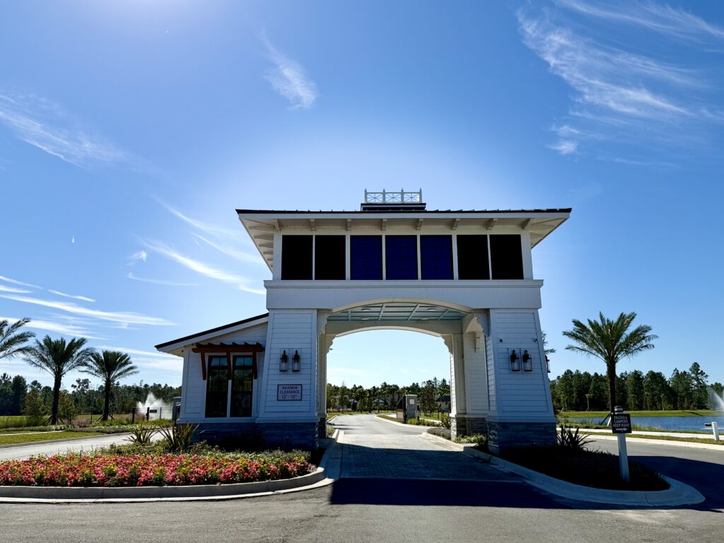 Community entry gatehouse with landscaped approach