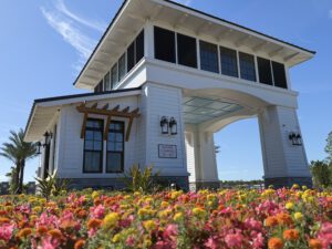 Community gatehouse entry with flower landscaping