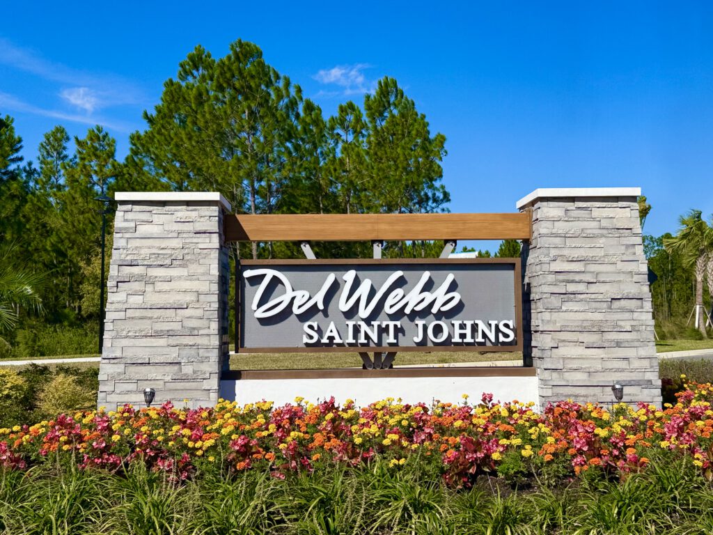 Del Webb Saint Johns entry monument sign with stone columns and flowers