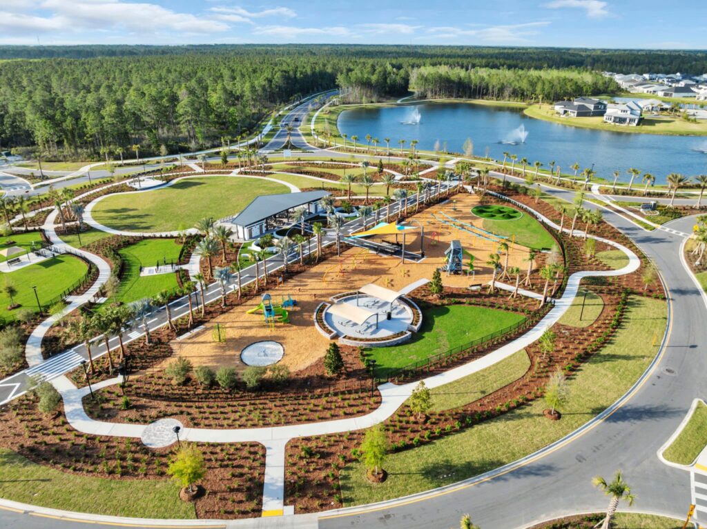 Aerial view of the Skipping Stone amenity park with playground, pavilion and lake