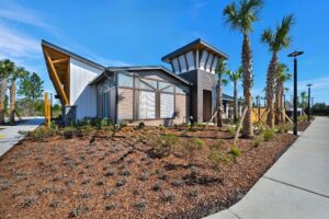 Clubhouse exterior with tower entry and palm landscaping at The Landings at St Johns