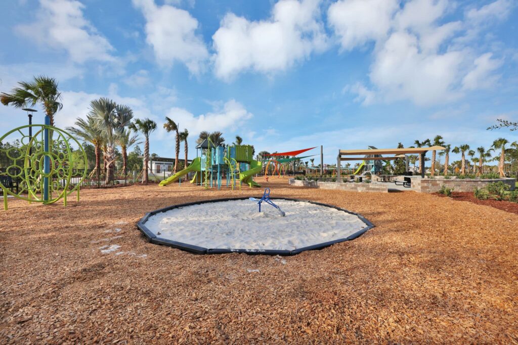Playground with sand play area and climbing structures at Skipping Stone
