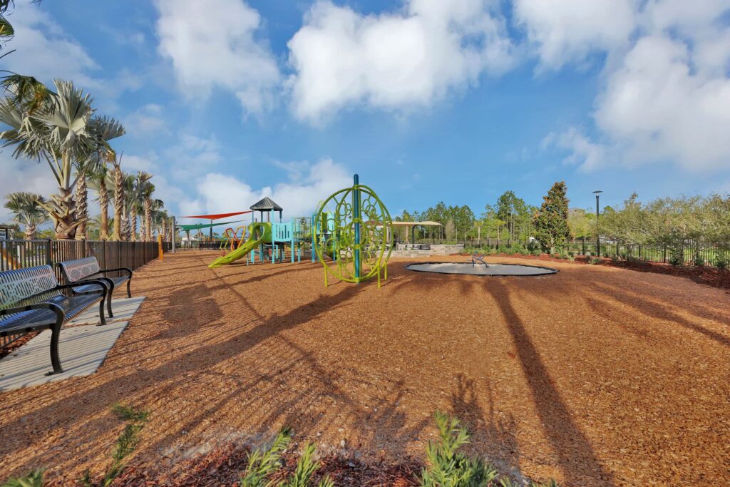 Benches beside the playground and play equipment at Skipping Stone