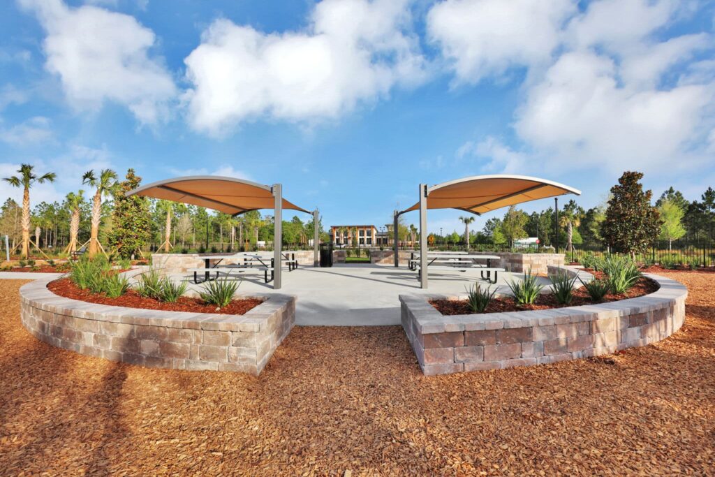 Shade pavilions and stone seat walls at the Skipping Stone community park