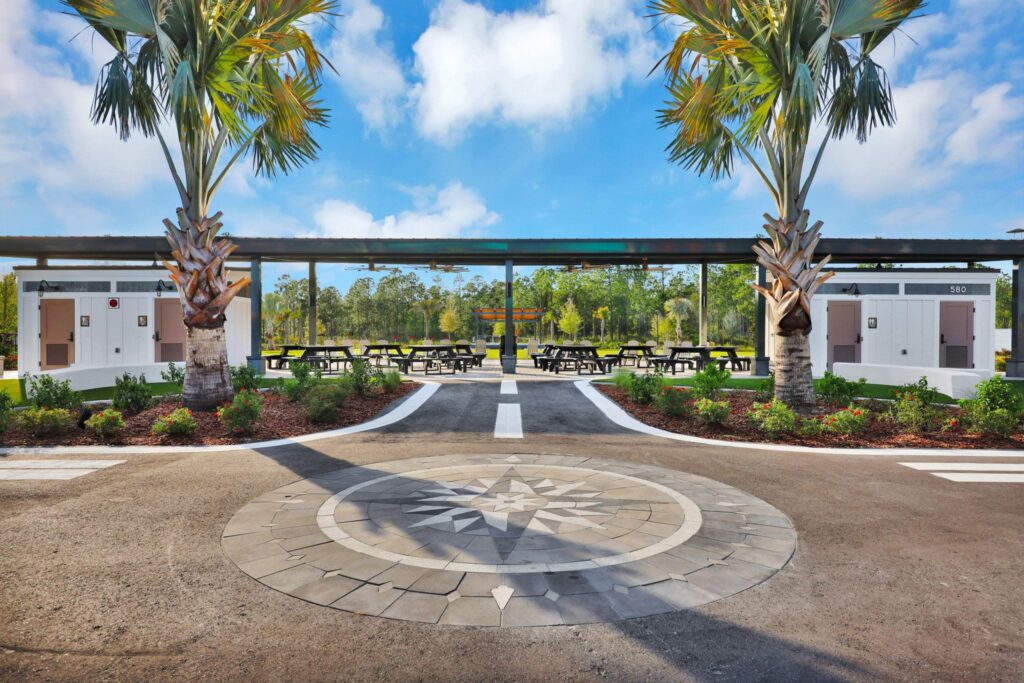 Covered picnic pavilion and compass-rose plaza at the Skipping Stone park