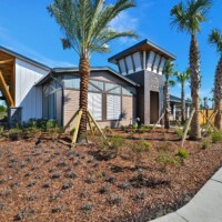 Amenity center exterior with palm landscaping at The Landings at St Johns