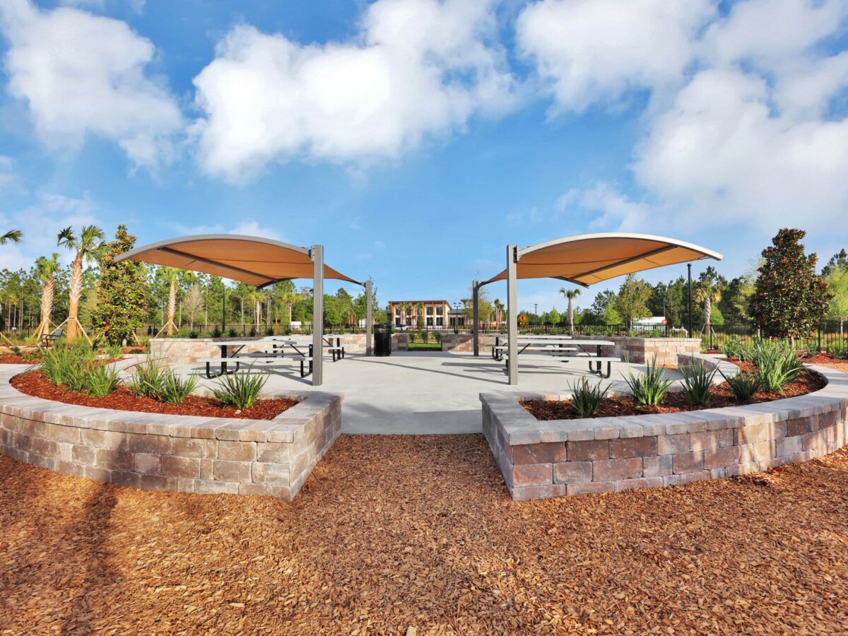 Shade pavilions and stone seat walls at the Skipping Stone community park