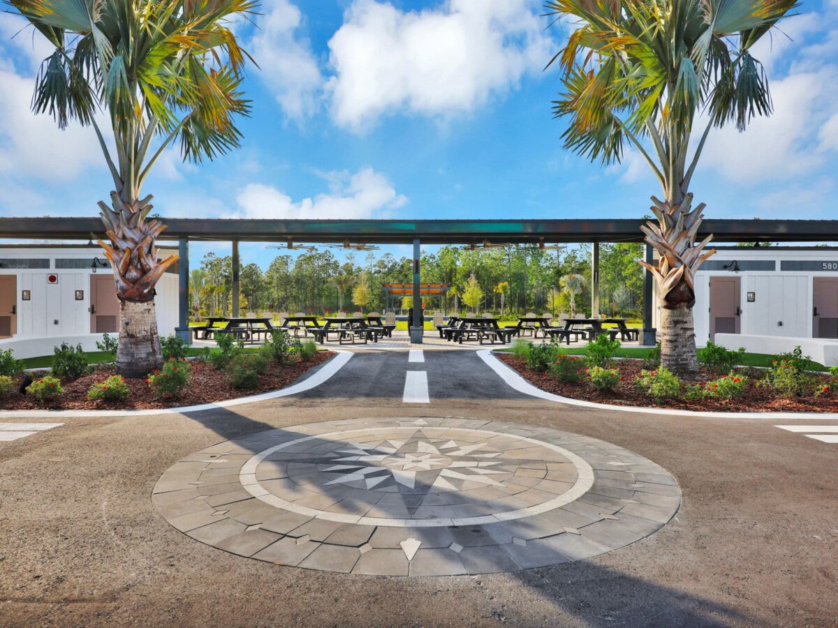 Covered picnic pavilion and compass-rose plaza at the Skipping Stone park