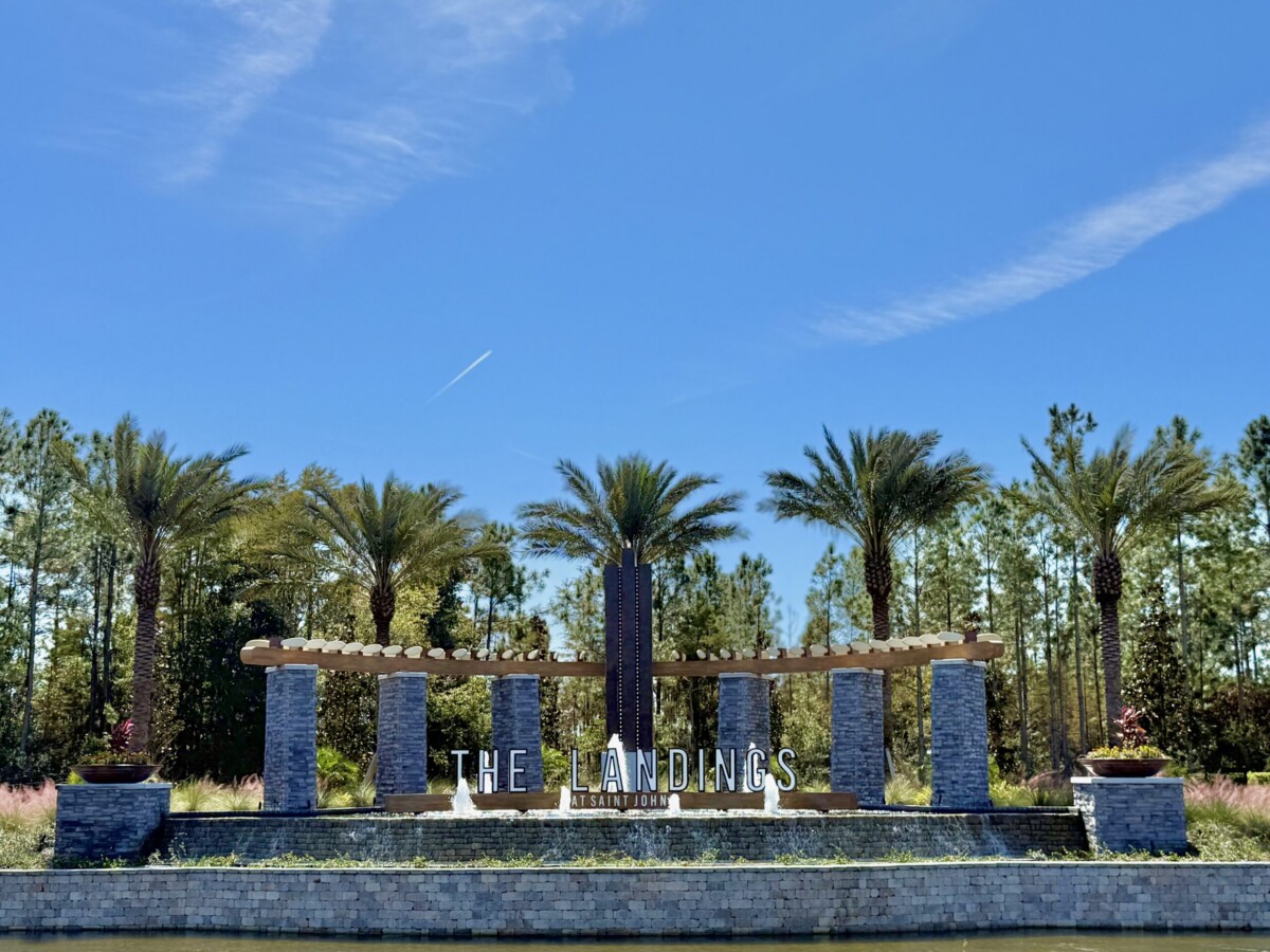 The Landings at St Johns entrance monument with stone columns, fountains and palms
